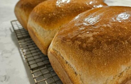 photo of soft sourdough sandwich bread cooling on a wire wrack