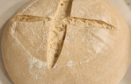 photo of a scored dough ready to into the oven to bake traditional sourdough loaf